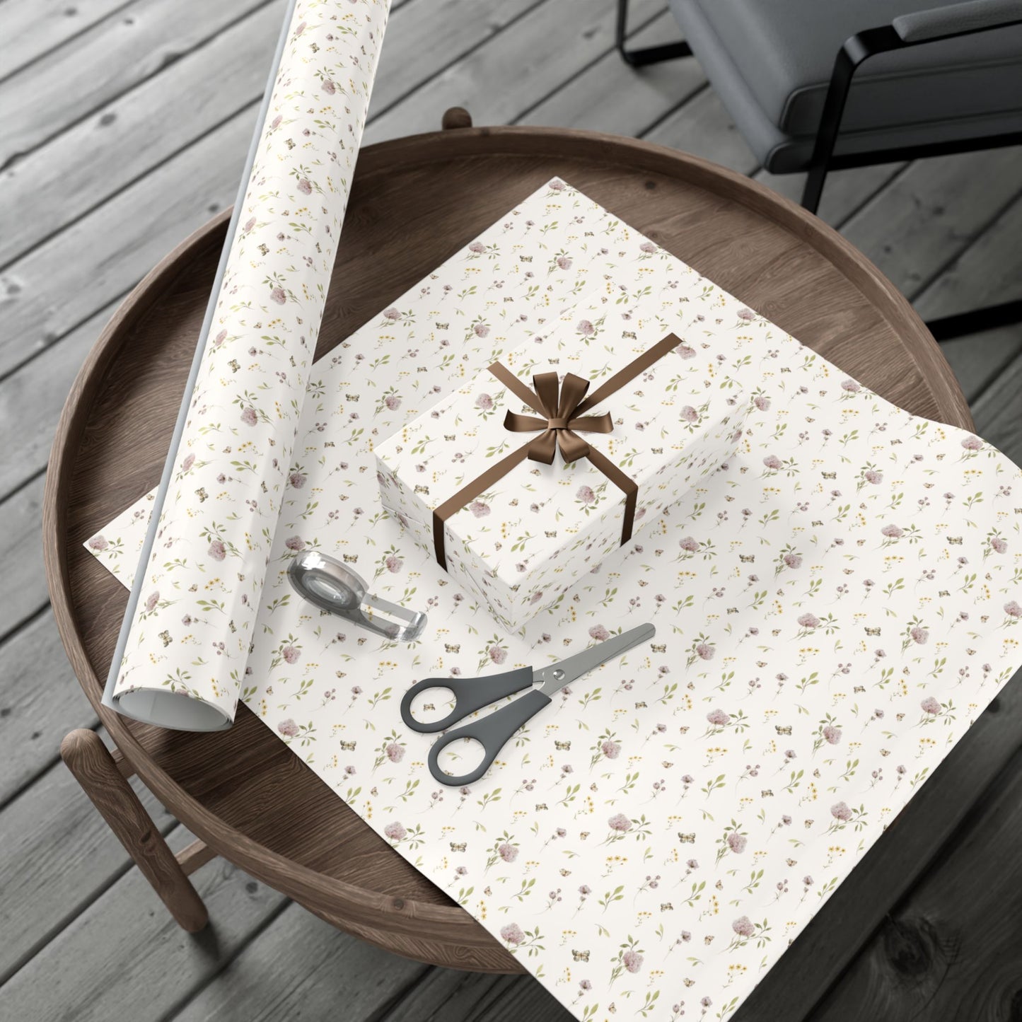 Petits Animaux floral-patterned gift wrap with scissors on a wooden surface