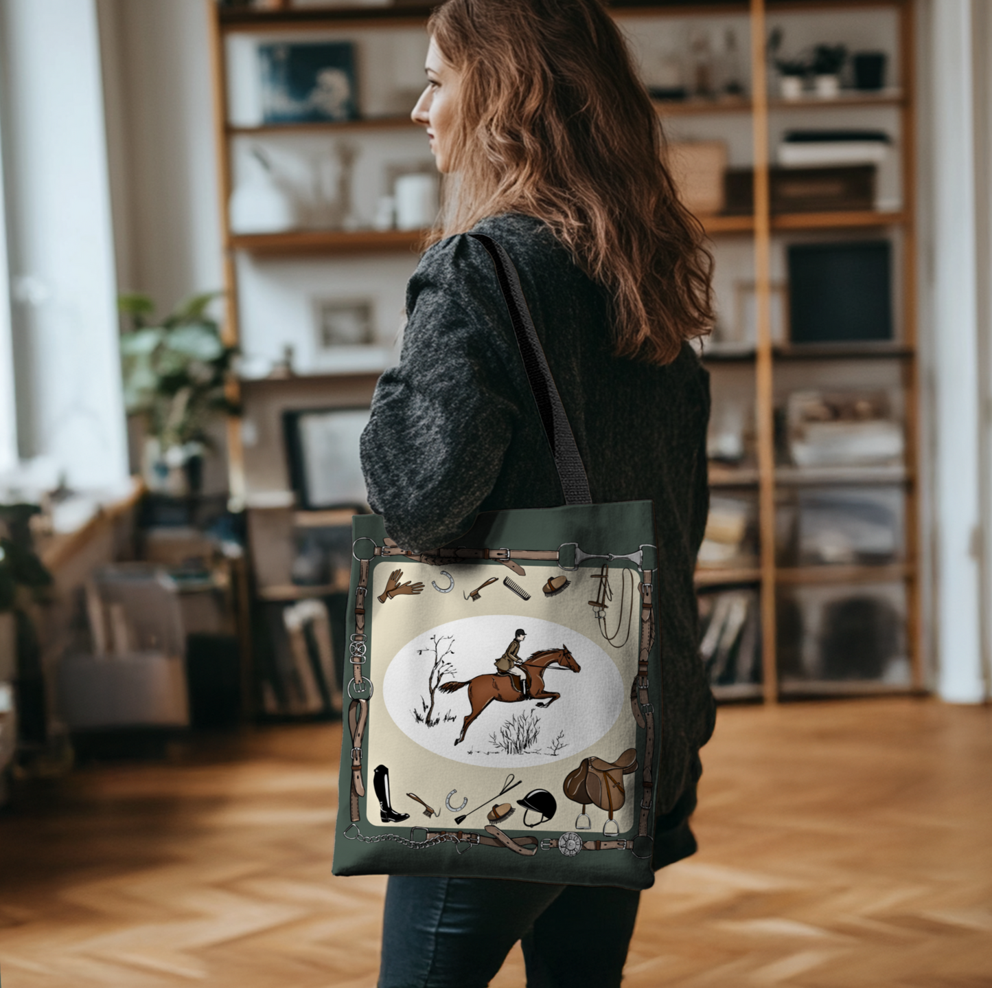 Person holding a tote bag with horse and jockey design in a room with bookshelves.