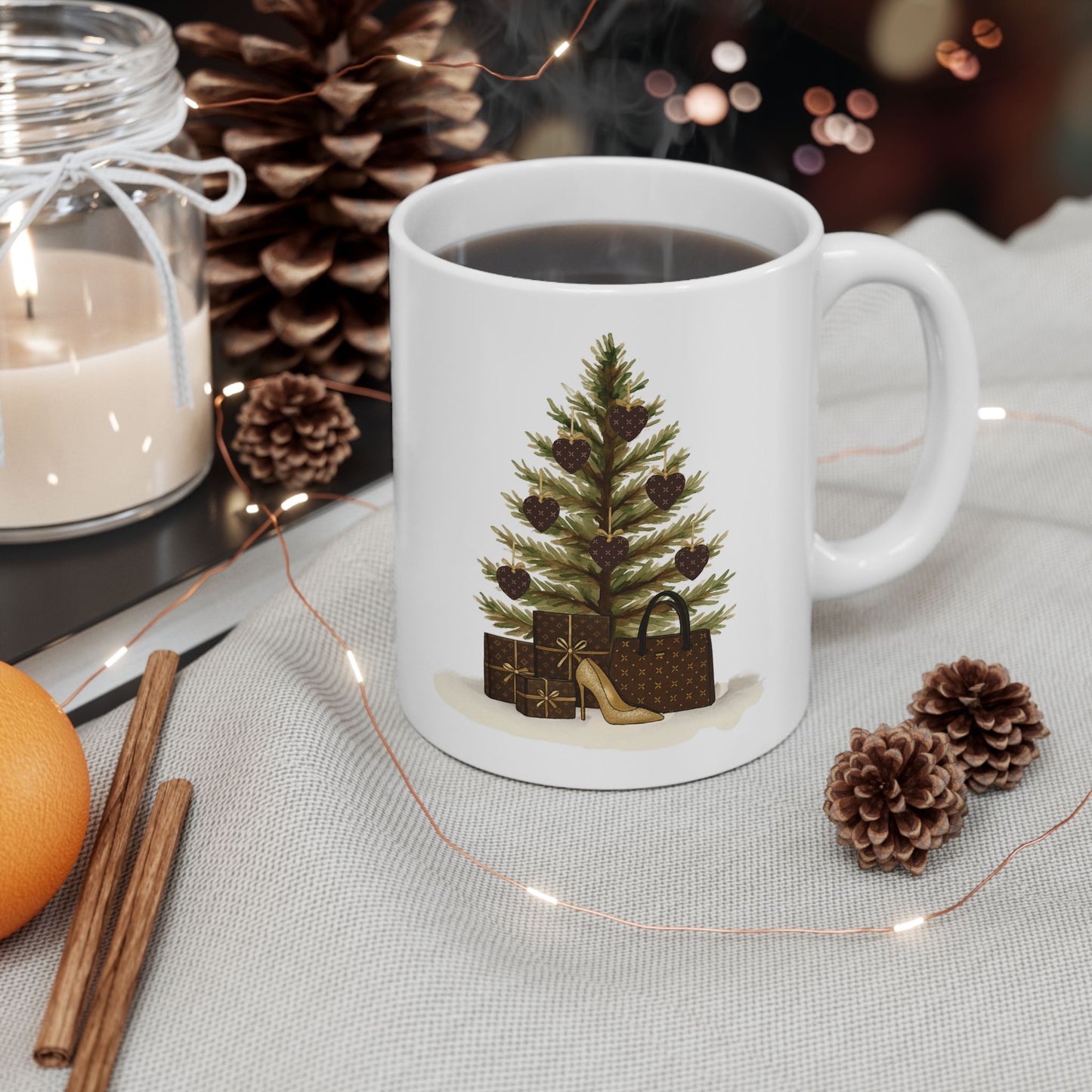 White mug with a Christmas tree design on a table with decorative items