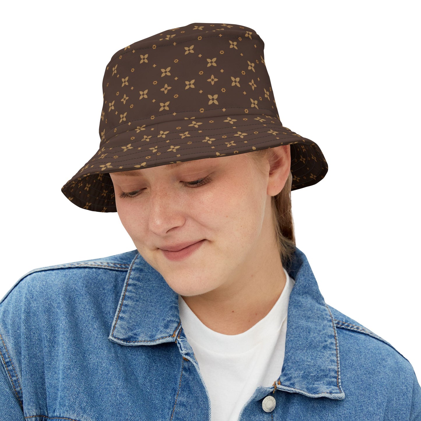 Person wearing a brown patterned bucket hat on a white background