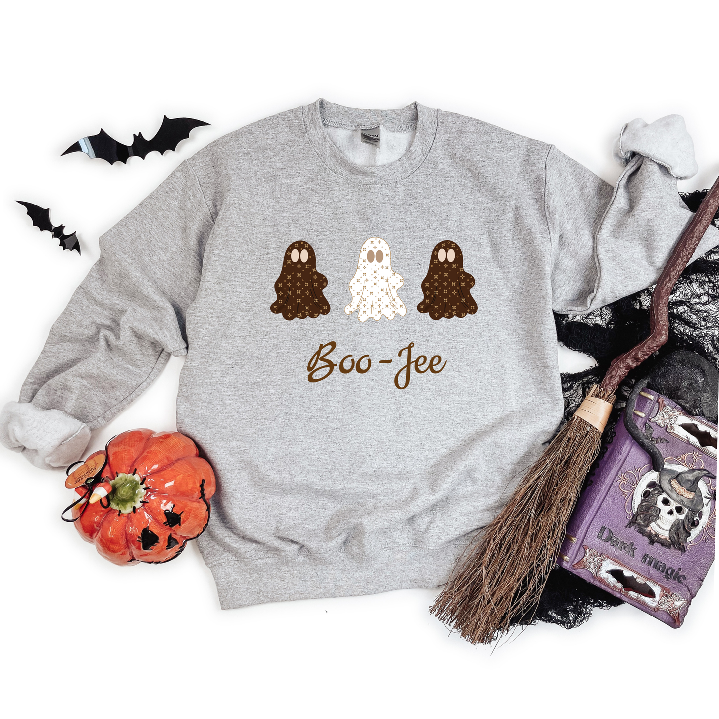 Gray sweatshirt with Halloween-themed design featuring ghosts and 'Boo-Jee' text, surrounded by Halloween decor.