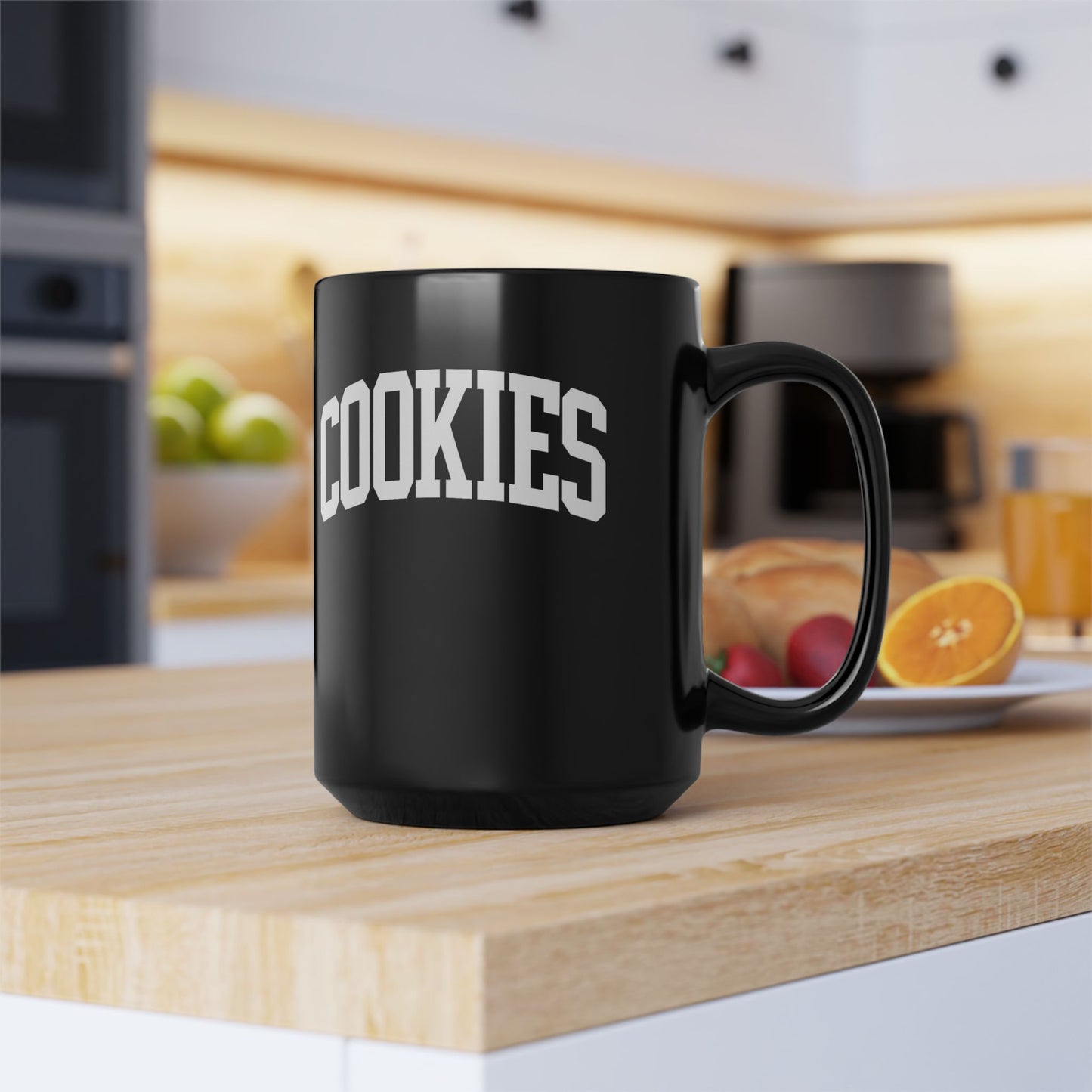 Black mug with 'COOKIES' text on a kitchen counter