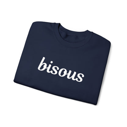 Folded navy blue shirt with 'bisous' text on a white background