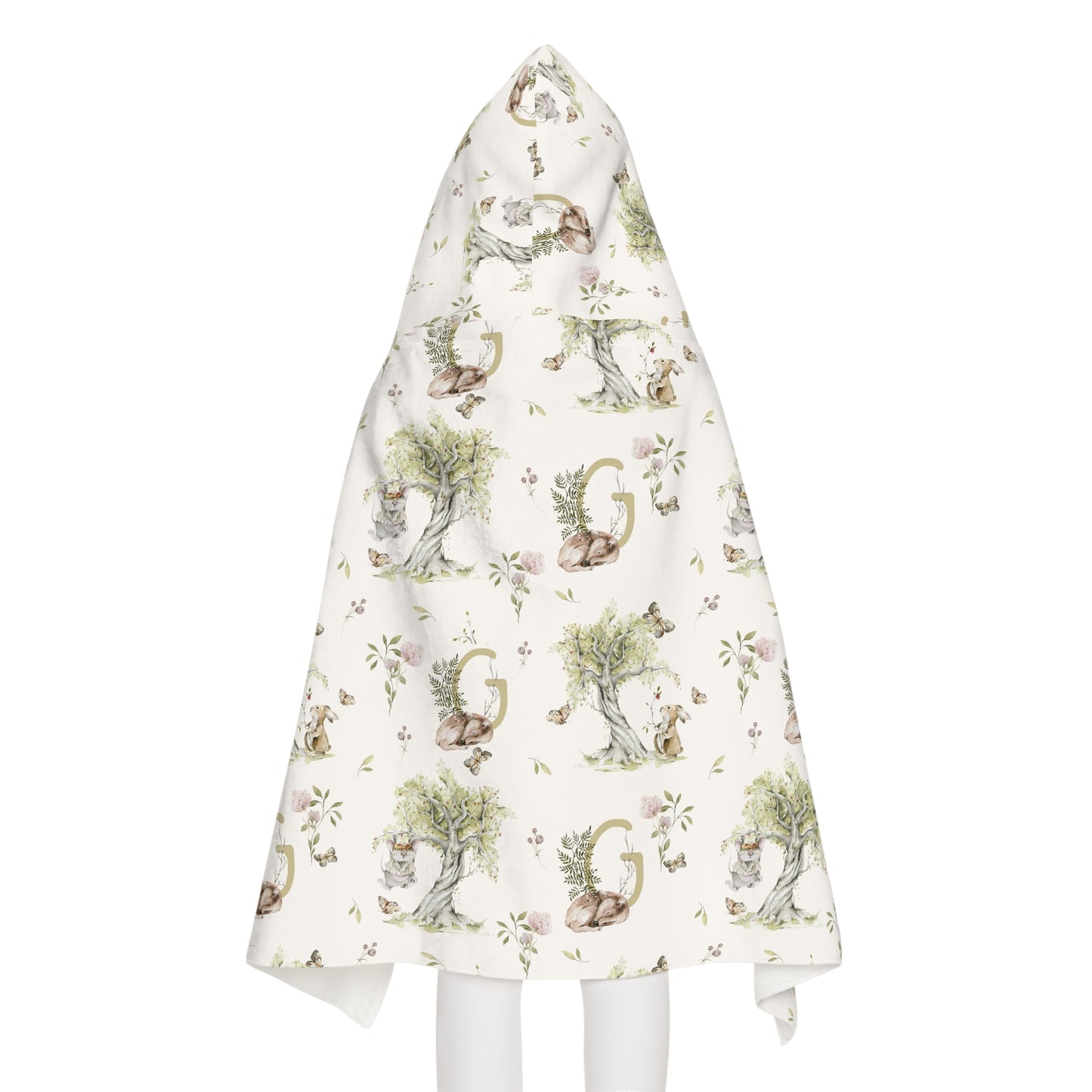 Child wearing a patterned hooded towel with watercolor mice and bunnies and a monogrammed initial in a bathroom