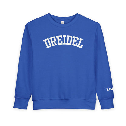 Blue sweatshirt with 'DREIDEL' printed on it against a white background