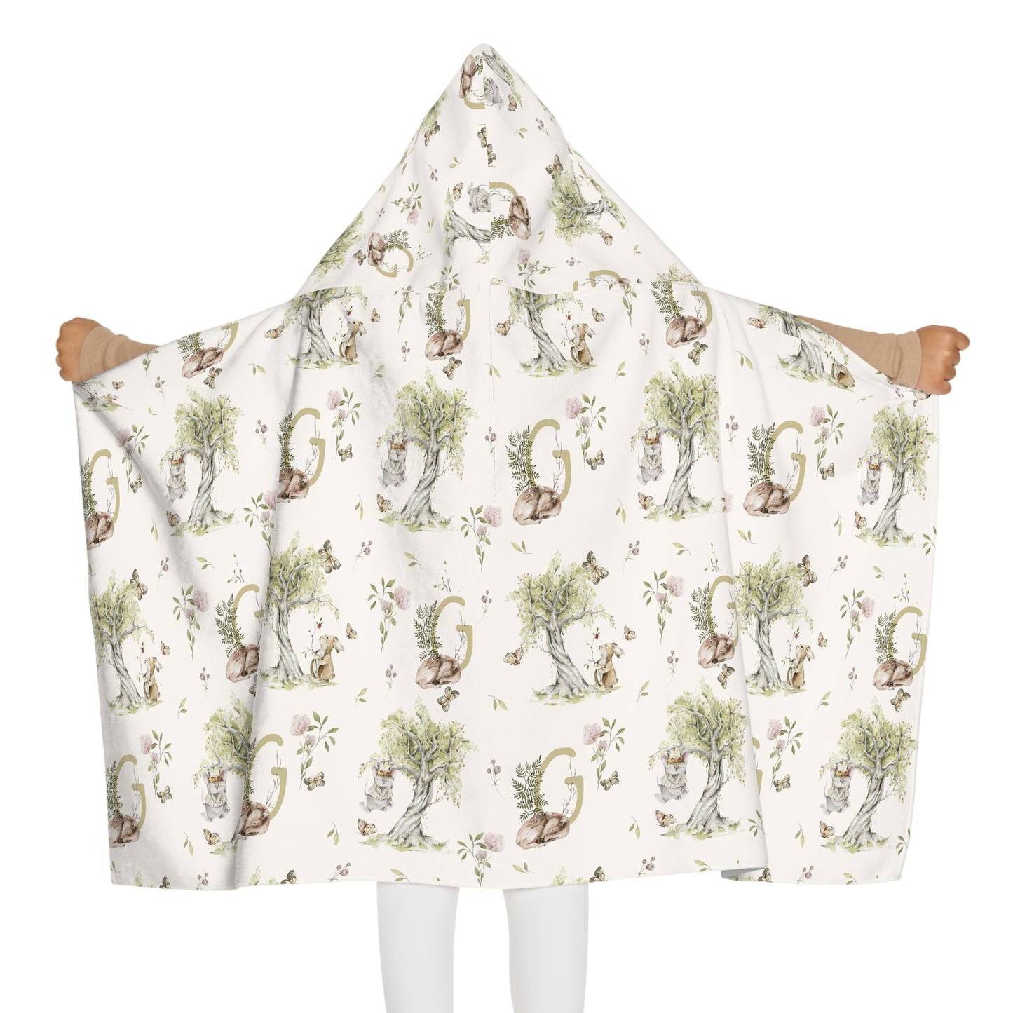 Child wearing a patterned hooded towel with watercolor mice and bunnies and a monogrammed initial in a bathroom