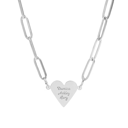 Silver heart-shaped pendant with engraved names on a white background