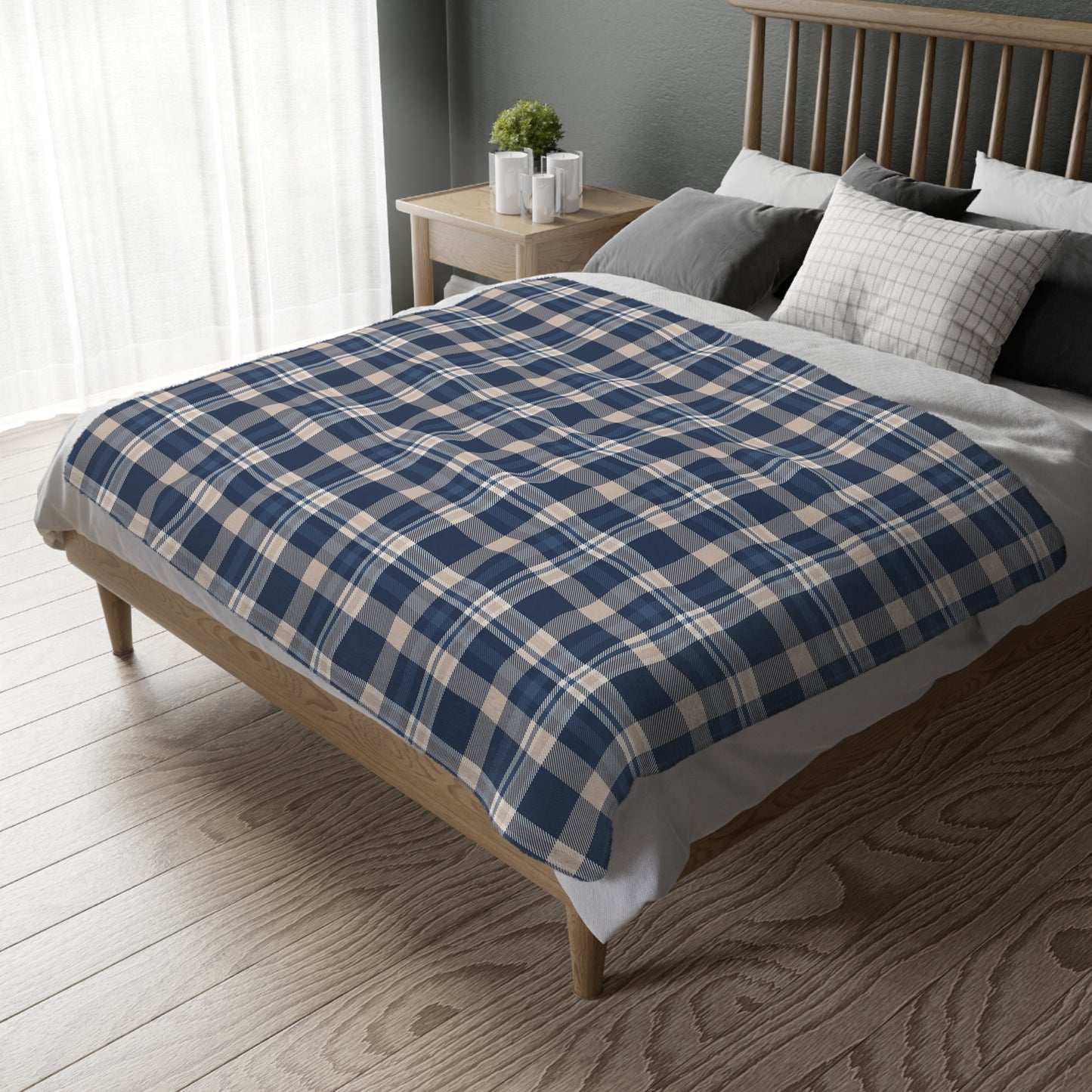 Bed with blue and beige checkered blanket in a bedroom setting