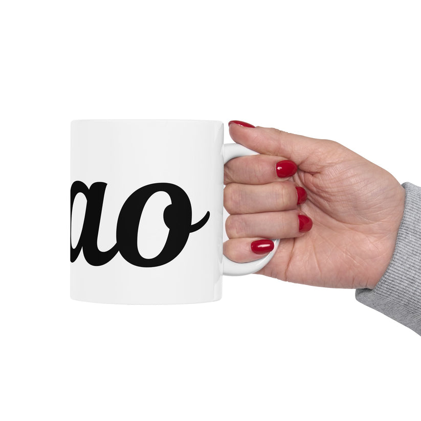 Hand holding a white mug with 'ciao' printed on it against a white background