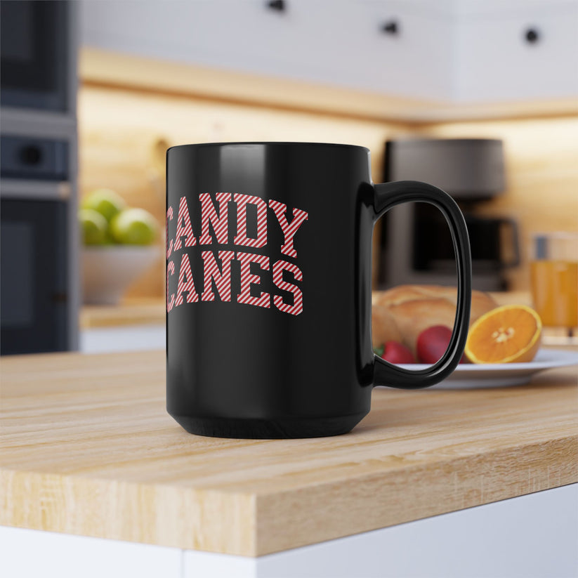 Black mug with 'CANDY CANES' text on a kitchen counter