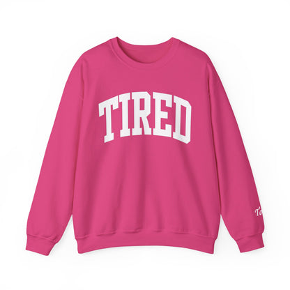 Pink sweatshirt with 'TIRED' text on a white background