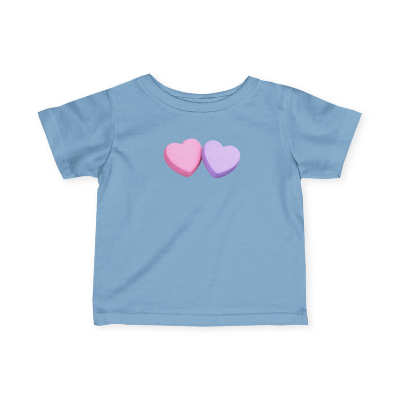 Light blue t-shirt with two colorful hearts on a white background