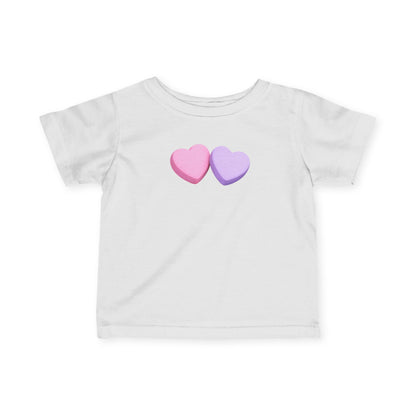 White t-shirt with pink and purple heart designs on a white background