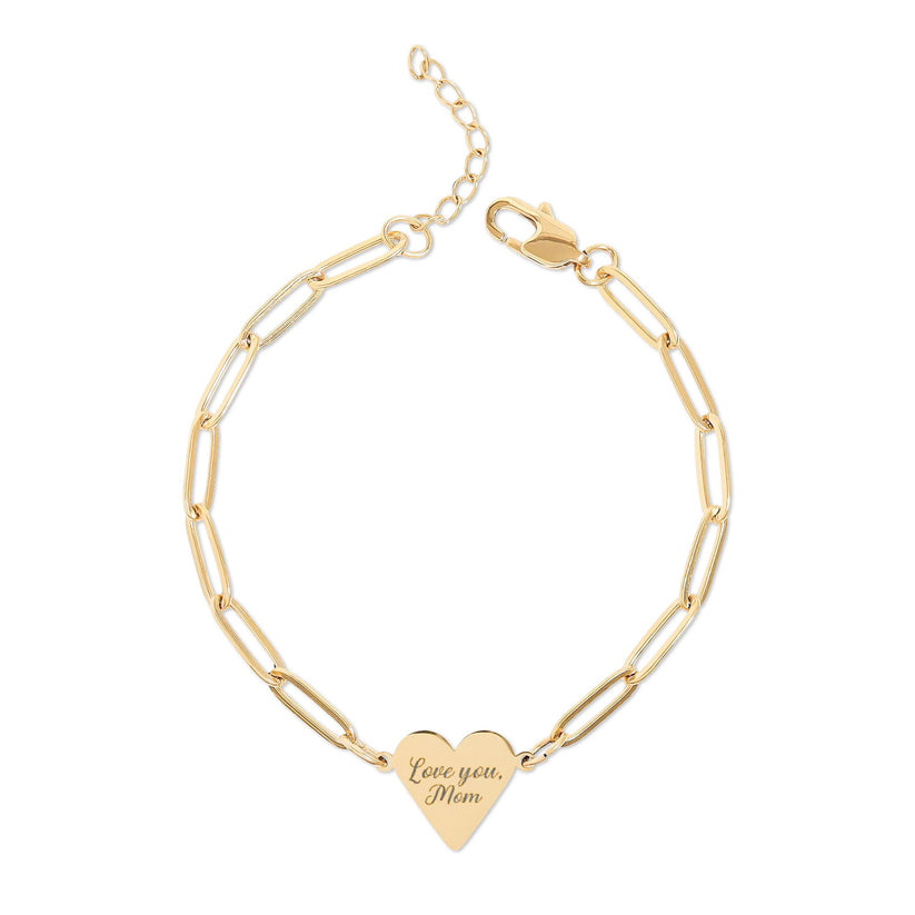 Gold bracelet with a heart-shaped tag on a white background