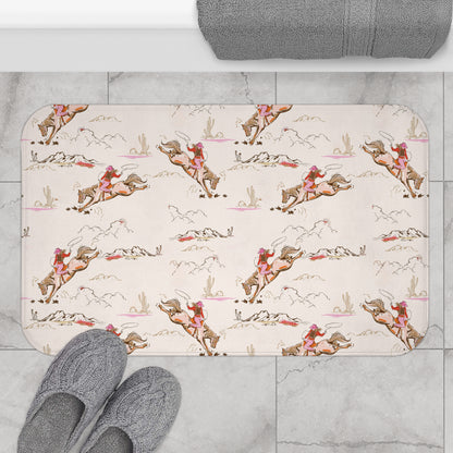 Patterned bath mat with a vintage cowgirl and bucking bronco print in pink tones.