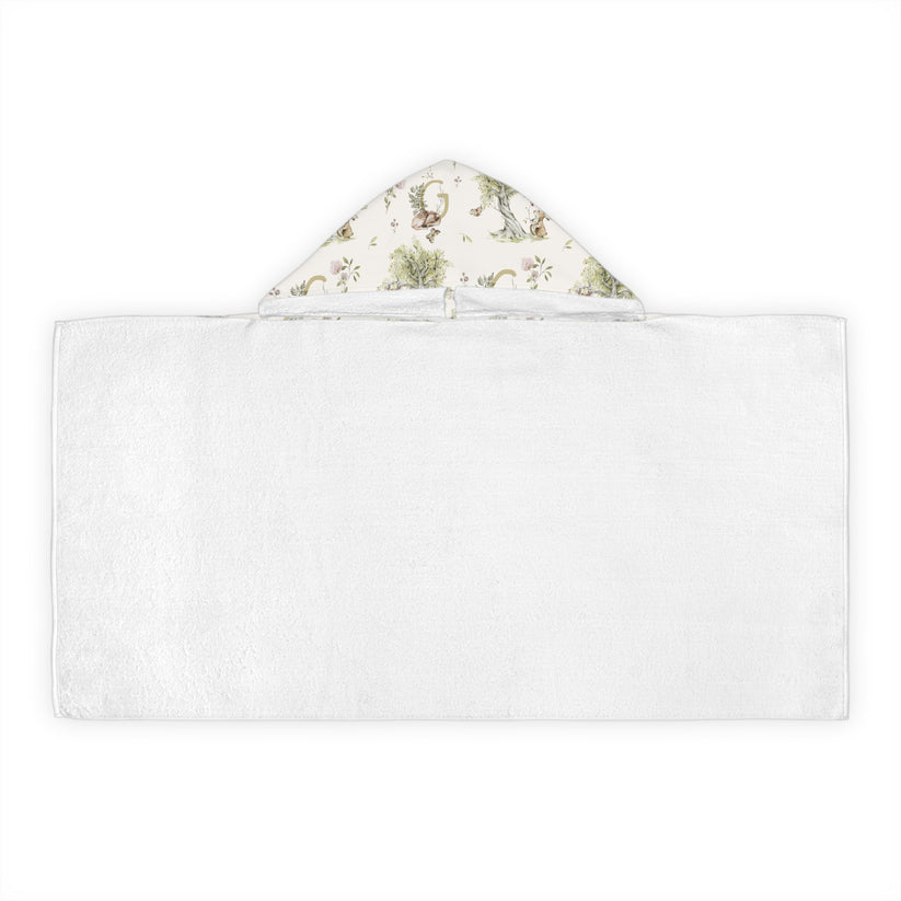 Patterned hooded towel with watercolor mice and bunnies and a monogrammed initial in a bathroom