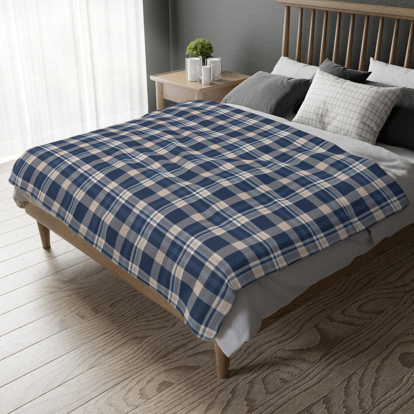 Bed with blue and beige checkered duvet in a bedroom setting
