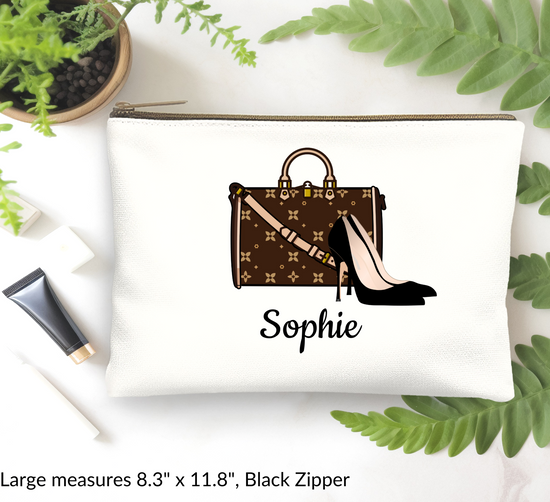 White pouch with brown handbag and high heels design, featuring the name 'Sophie', on a white background with green leaves.