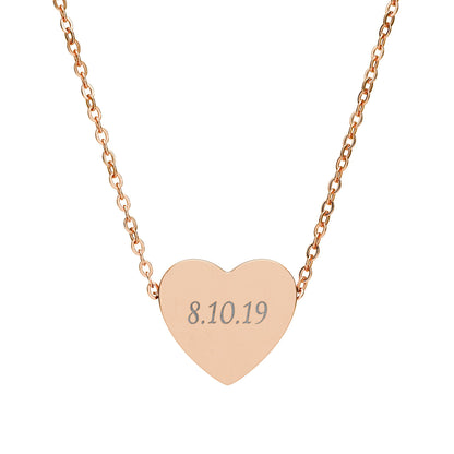 Rose gold heart-shaped necklace with engraved date on a white background