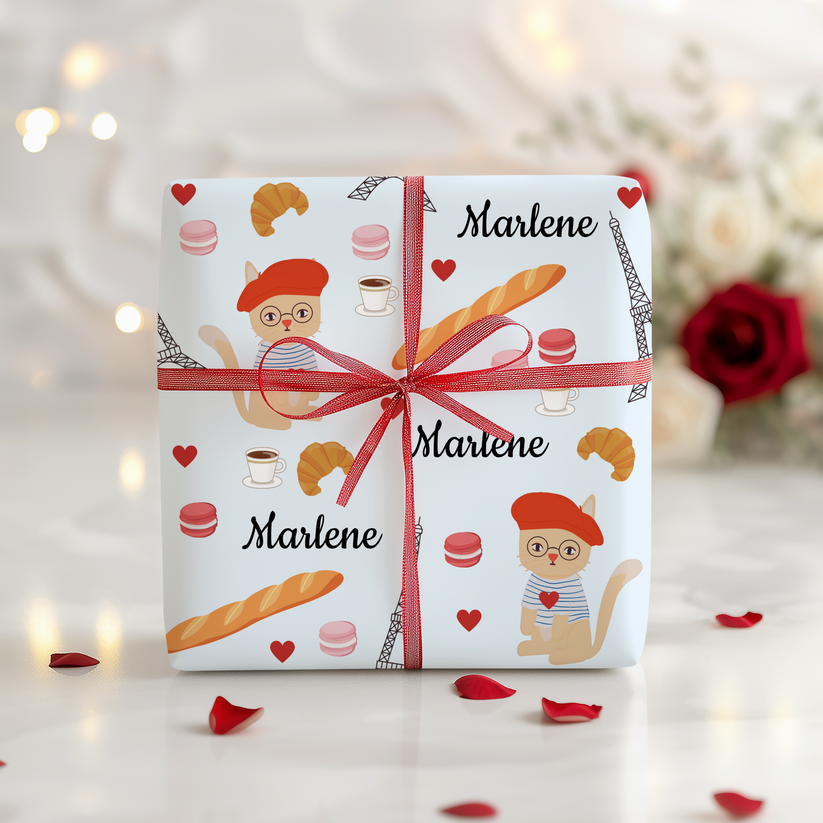 Box wrapped in Chic Parisian Cat wrapping paper.  Light blue background with a cat in a beret, macarons, coffee, croissants and the Eiffel Tower.