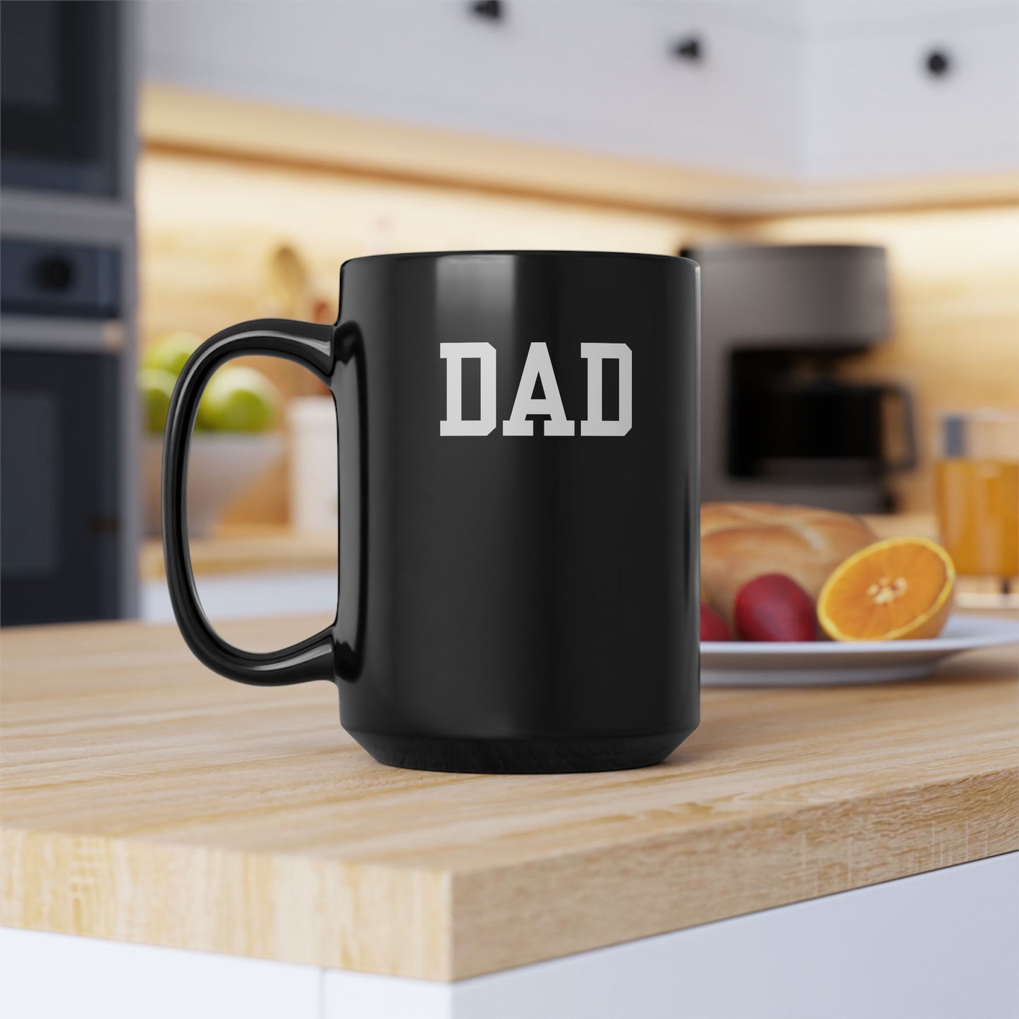 Black mug with 'DAD' text on a kitchen counter