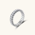 Sterling silver eternity ring with continuous row of brilliant moissanite stones in scalloped crown setting with milgrain detail