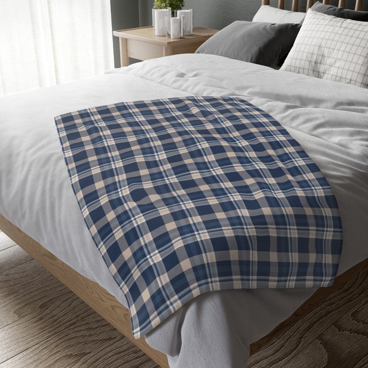 Blue and white plaid blanket on a bed in a bedroom setting