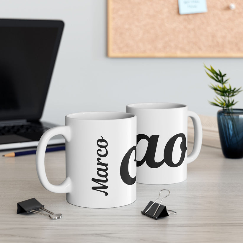 Two white mugs with 'Marco' and 'Ciao' text on a desk with office items.