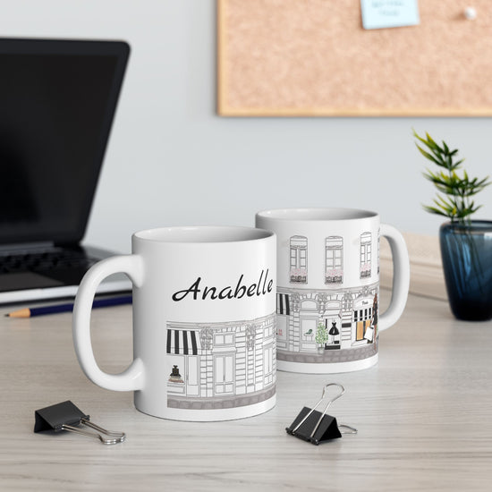 Two mugs on a desk with one labeled 'Anabelle' and back of Haute in Paris Collection mug personalized with customer’s name in elegant script.

haute in paris 