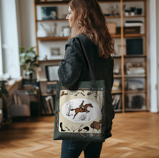 Person holding a tote bag with horse and jockey design in a room with bookshelves.