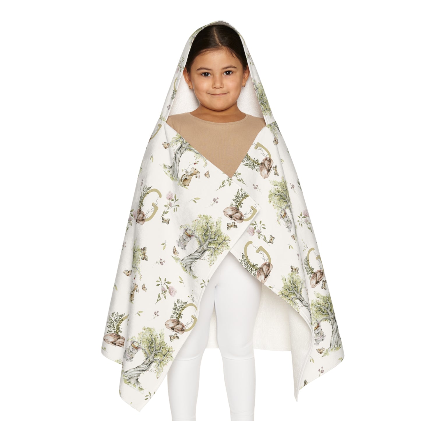 Child wearing a patterned hooded towel with watercolor mice and bunnies and a monogrammed initial in a bathroom