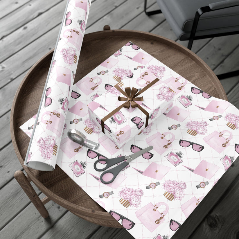 Pink and white fashion theme patterned gift wrap with scissors on a wooden table