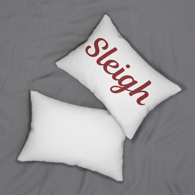 Two white pillows on a gray surface, one plain and one with 'Sleigh' printed on it.