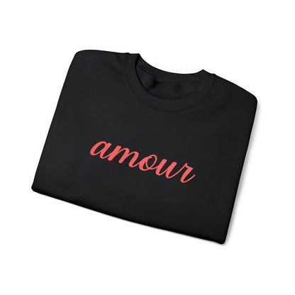 Folded black sweatshirt with 'amour' text in red on a white background
