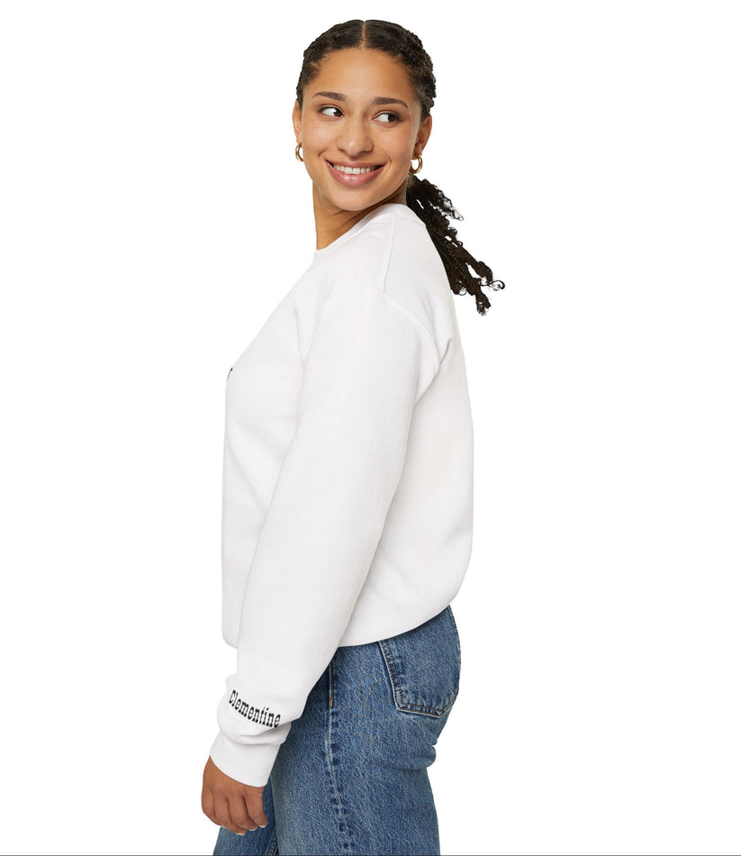 Woman wearing a white sweatshirt with text on sleeves and blue jeans against a white background