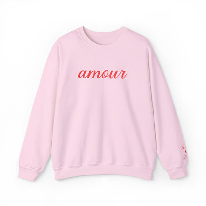 Pink sweatshirt with 'amour' text on a white background