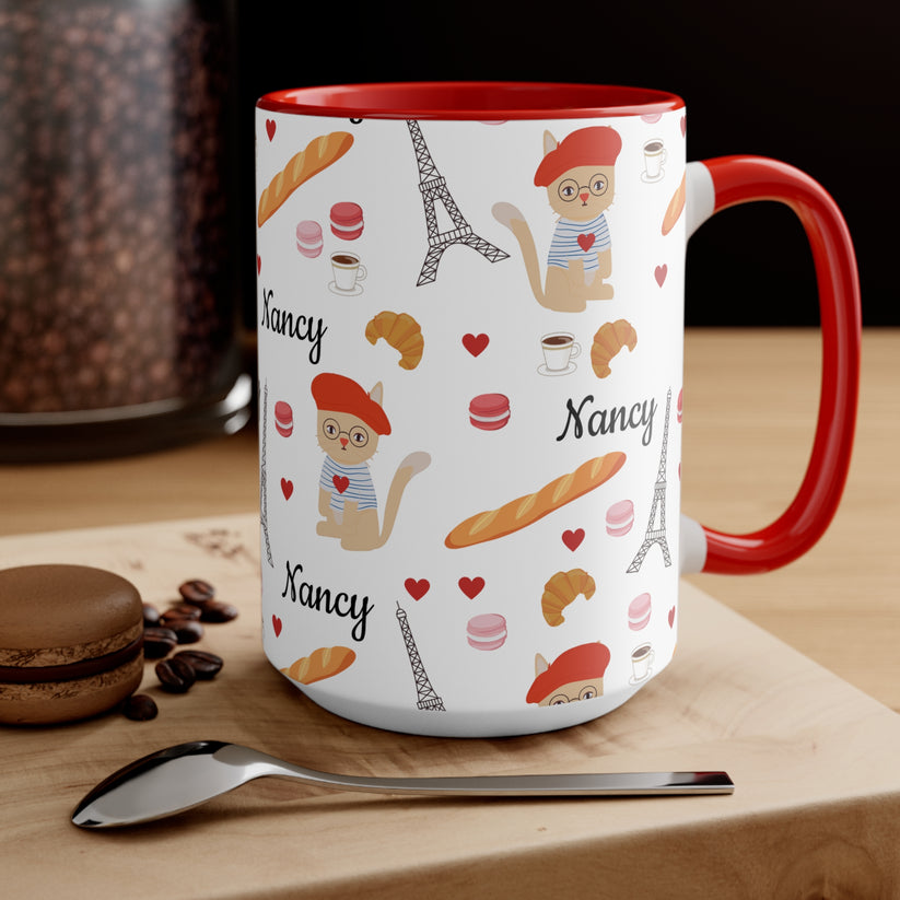 Mug with red handle featuring cat in a red beret surrounded by Parisian items  personalized name on a kitchen counter.