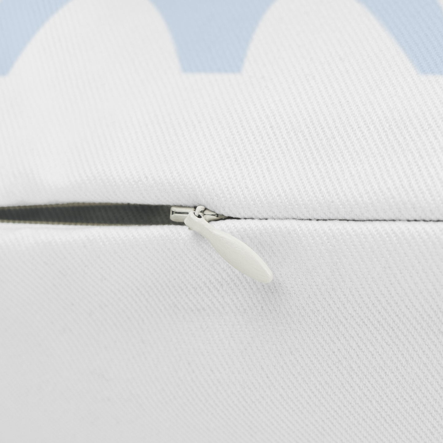 Close-up of a white jacket with a zipper on a light blue background