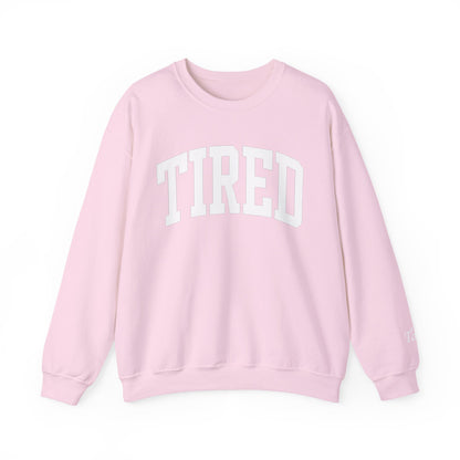 Pink sweatshirt with 'TIRED' text on a white background
