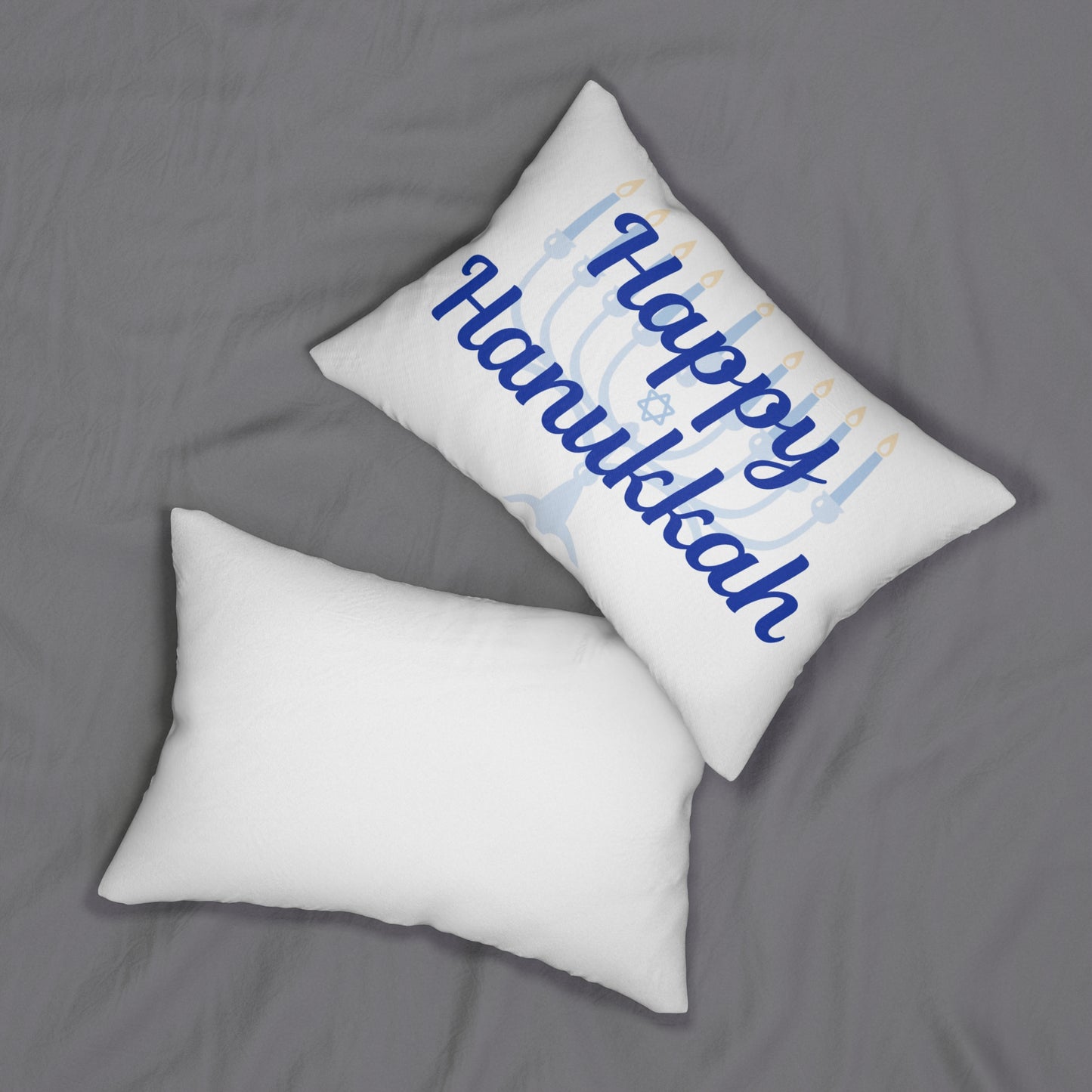White pillow with 'Happy Hanukkah' text on a gray background