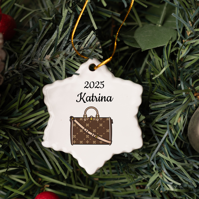 Decorative ornament with handbag design and '2025 Katrina' text on a green wreath.
