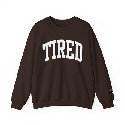 Brown sweatshirt with 'TIRED' text on a white background