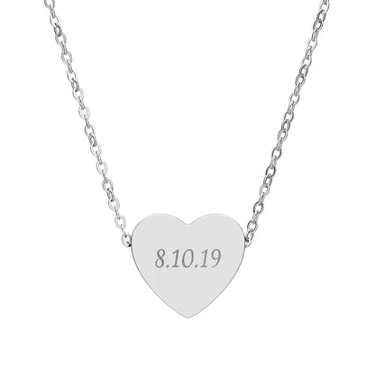 Silver heart-shaped necklace with engraved date on a white background