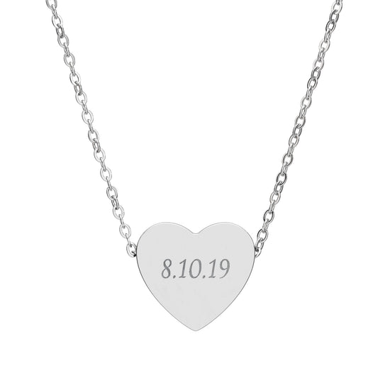 Silver heart-shaped necklace with engraved date on a white background
