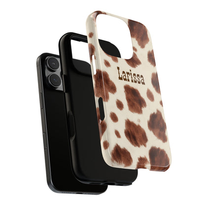 Phone case with cow print pattern and 'Larissa' branding on a white background