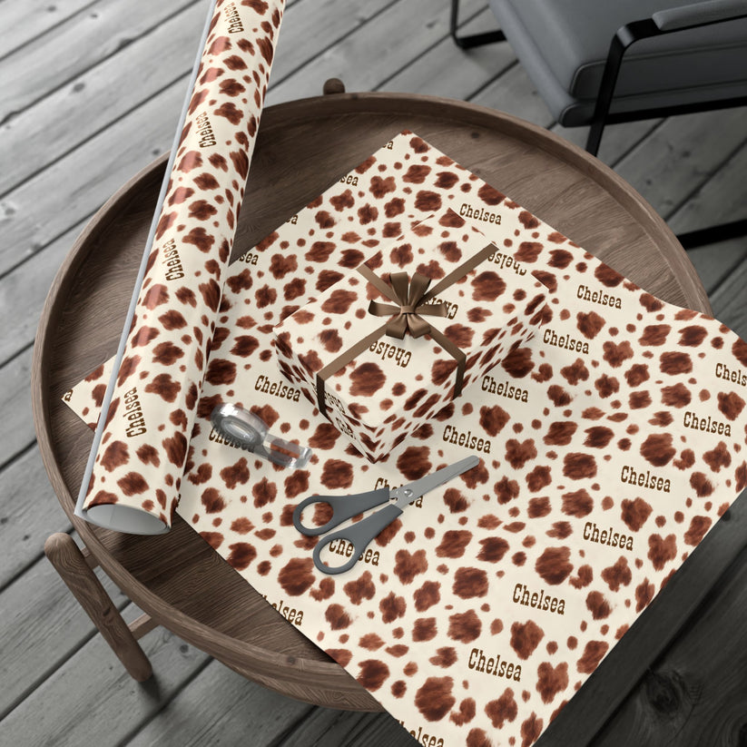 Roll of leopard print fabric with 'Chelsea' branding on a wooden surface.