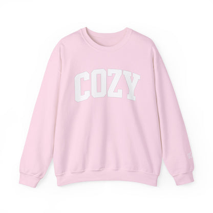 Pink sweatshirt with 'COZY' text on a white background