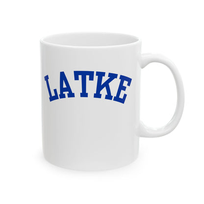 White mug with 'LATKE' printed in blue on a white background