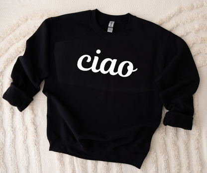 Black sweatshirt with 'ciao' text on a textured beige surface