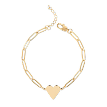 Gold bracelet with a heart charm on a white background